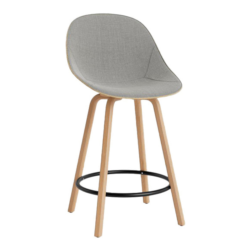 Light gray upholstered bar stool with wooden legs and a sleek black footrest. Modern and minimalist design.