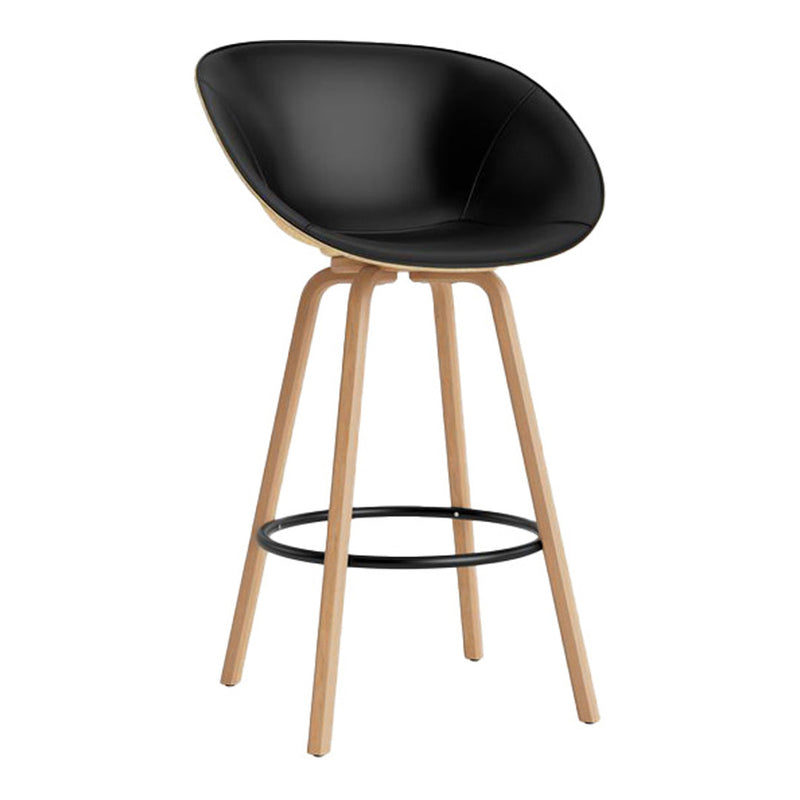 Sleek black curved seat with natural wood legs and black footrest, featuring a minimalist design aesthetic.