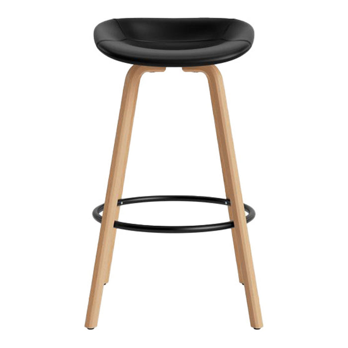 Modern black bar stool with natural wood legs and black metal footrest, featuring a sleek, minimalist design.