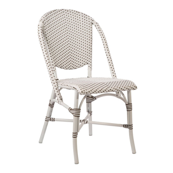 White chair with a textured pattern of small brown dots, featuring a woven design and light-colored frame.