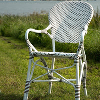 White and brown woven outdoor chair with a round backrest, featuring a stylish pattern and durable construction.