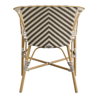 Chevron pattern in neutral tones of beige and dark brown on a stylish curved chair with a natural bamboo frame.