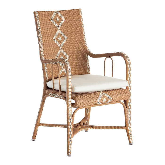 Natural wicker chair in warm beige with intricate cream diamond patterns, featuring a plush white cushion.