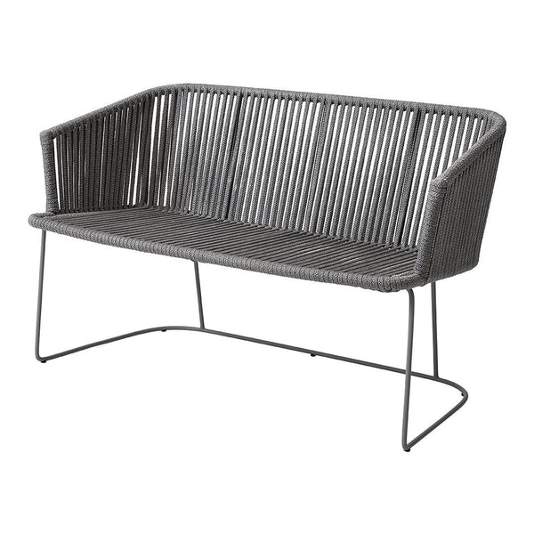 Gray woven loveseat with vertical striped pattern and minimalist metal frame. Ideal for modern outdoor spaces.