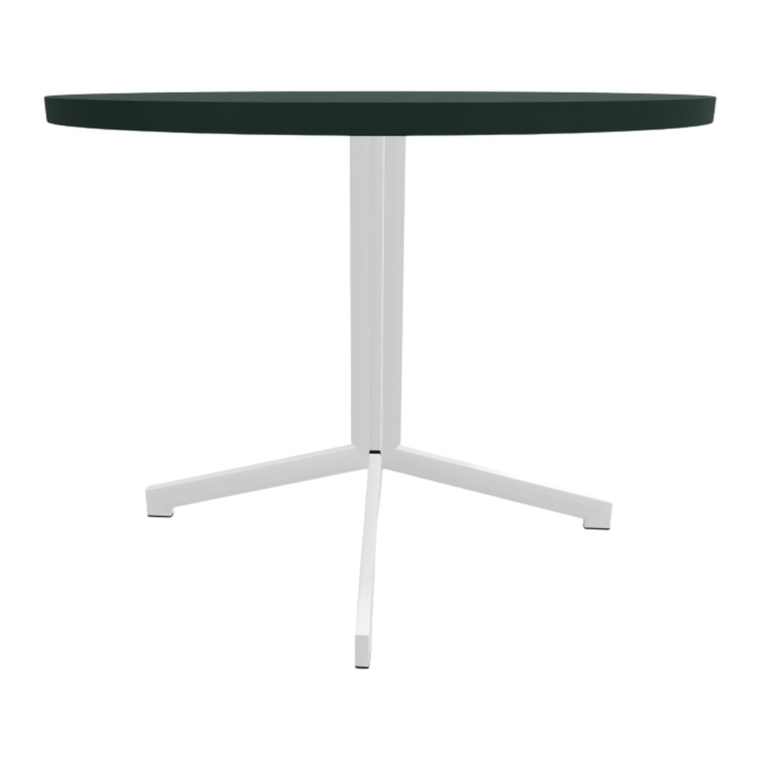 Round table with a deep green tabletop and sleek white metal legs, minimalist design and modern colors.