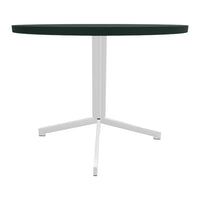 Round table with a deep green tabletop and sleek white metal legs, minimalist design and modern colors.