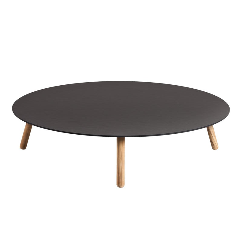 Round black coffee table with natural wood legs, featuring a sleek, minimalist design and smooth surface.