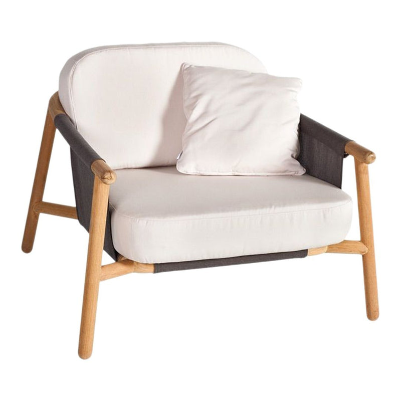 Cream and gray armchair with wooden accents, featuring a simple design and a cozy throw pillow.