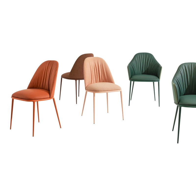 Set of modern dining chairs in terracotta, blush, brown, and green with ribbed cushions and sleek metal legs.