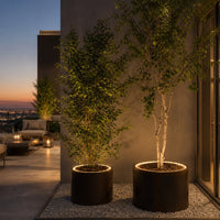 "Dark, textured planter pots with glowing edges, surrounded by lush green foliage against a twilight backdrop."
