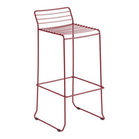 Red metal barstool with sleek, horizontal wire design and minimalistic aesthetic. Perfect for modern interiors.