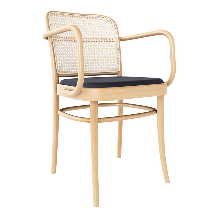 Natural rattan chair with a light wood frame and deep navy blue cushion, featuring a woven backrest pattern.