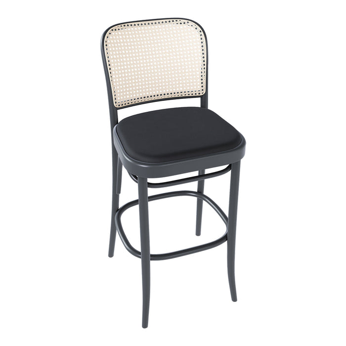 Black bar stool with a woven natural cane backrest and a padded seat for modern decor.