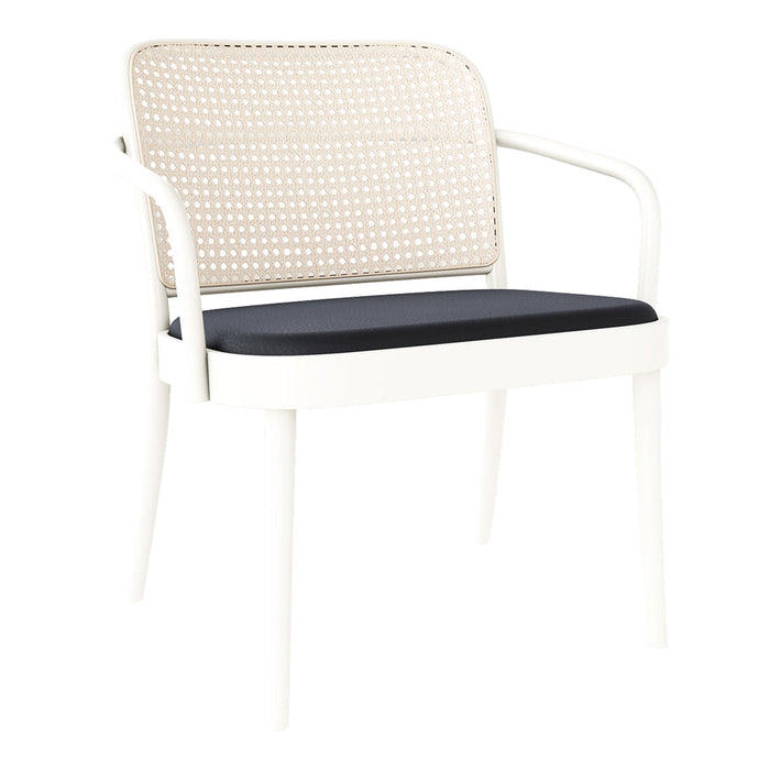 White chair with a woven rattan backrest and solid black cushion seat, adding a modern touch to any space.