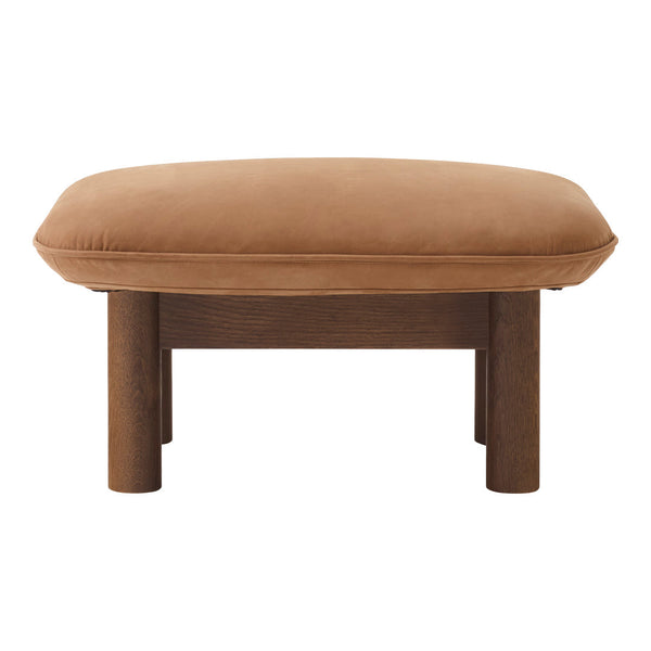 Brown suede ottoman with a smooth, rounded top and sturdy wooden legs. Stylish and modern furniture accent piece.