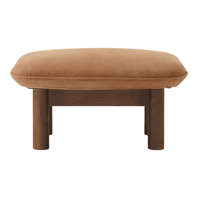 Brown suede ottoman with a smooth, rounded top and sturdy wooden legs. Stylish and modern furniture accent piece.