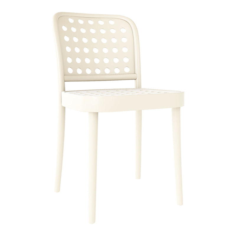 Cream-colored chair with a modern perforated design, featuring circular patterns and sleek, minimalist legs.