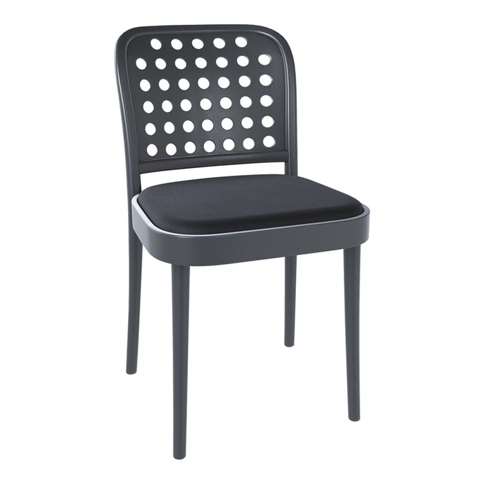 Black chair with circular cutout pattern in the backrest and a solid black cushioned seat.