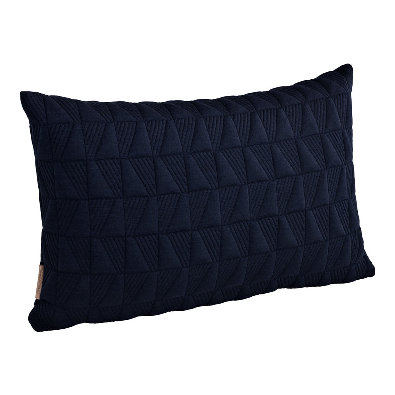 Navy blue textured pillow with a geometric pattern of raised triangles. Perfect for modern decor.