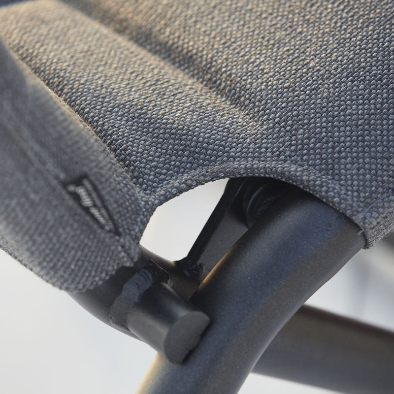 Close-up of a textured gray fabric with subtle patterns, highlighting the black metal frame and stitching details.
