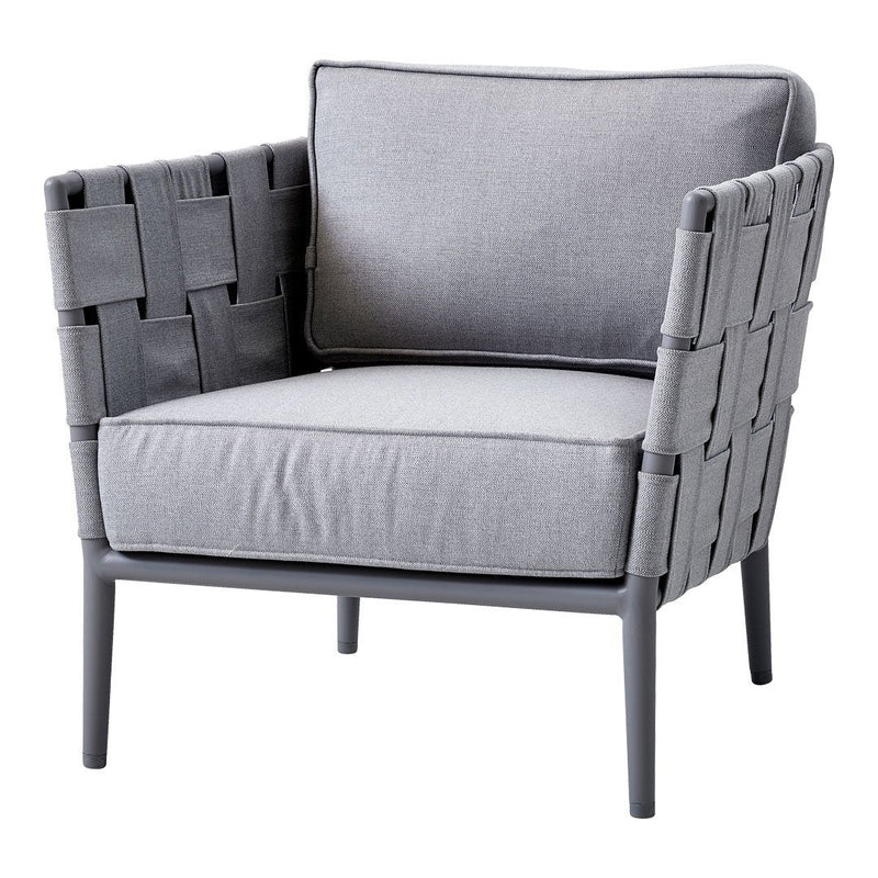 Grey woven chair with a gray fabric cushion and sleek metal legs, featuring a modern, minimalist design.