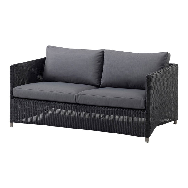 Stylish black wicker sofa with gray cushions, featuring a modern, minimalist design and subtle texture.