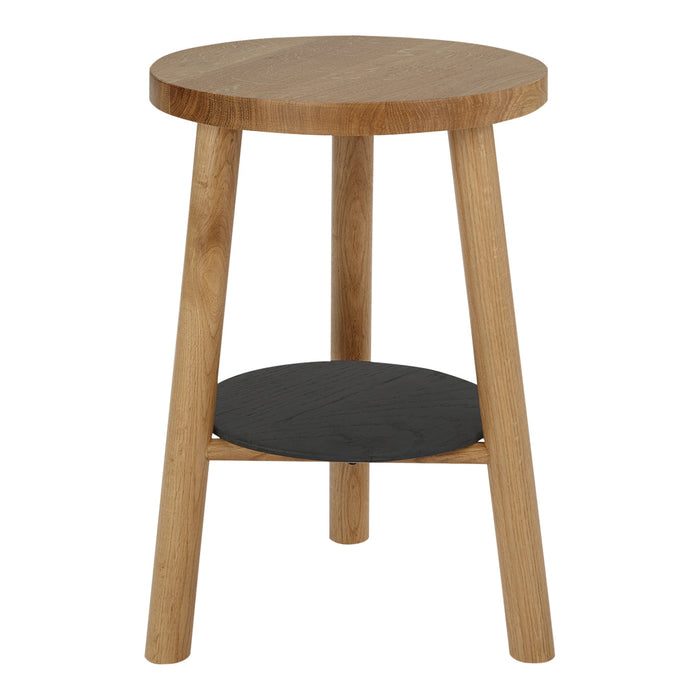 Round wooden side table with natural oak finish and a sleek black bottom shelf, showcasing a modern, minimalist design.
