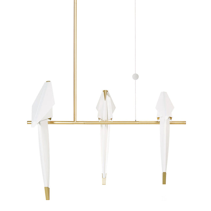 Elegant gold pendant light with three white fabric shades, featuring a minimalist design and modern aesthetic.