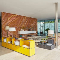 Yellow storage unit against a warm orange and brown marbled wall, featuring modern décor and sleek patterns.