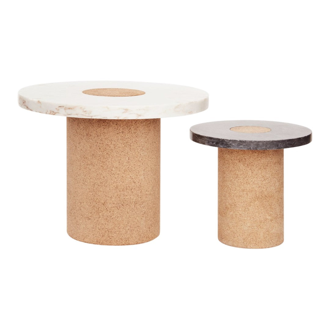 Cork accent tables with white and black circular tops, featuring natural wood grain patterns. Ideal for modern decor.