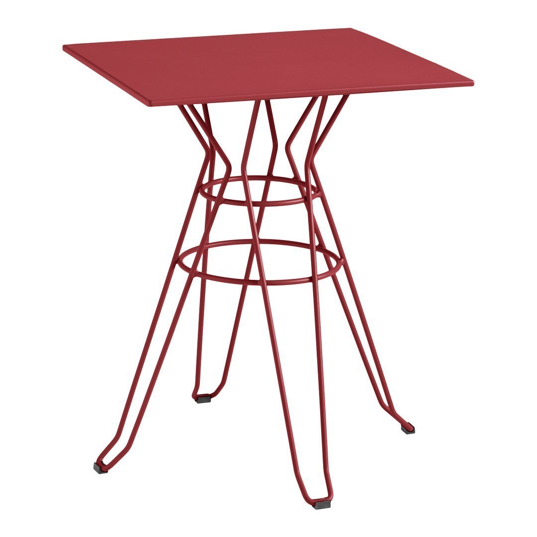 Red metal table with a geometric wire base, featuring a sleek, modern design and a vibrant matte finish.