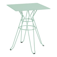 Mint green square tabletop with a geometric wire base, featuring sleek lines for a modern look.