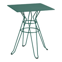 Green metal table with a geometric wire base, featuring a sleek square top and minimalist design for modern decor.