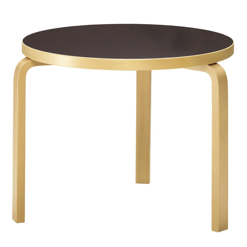 Round table featuring a sleek black top and elegant gold legs, perfect for modern decor.