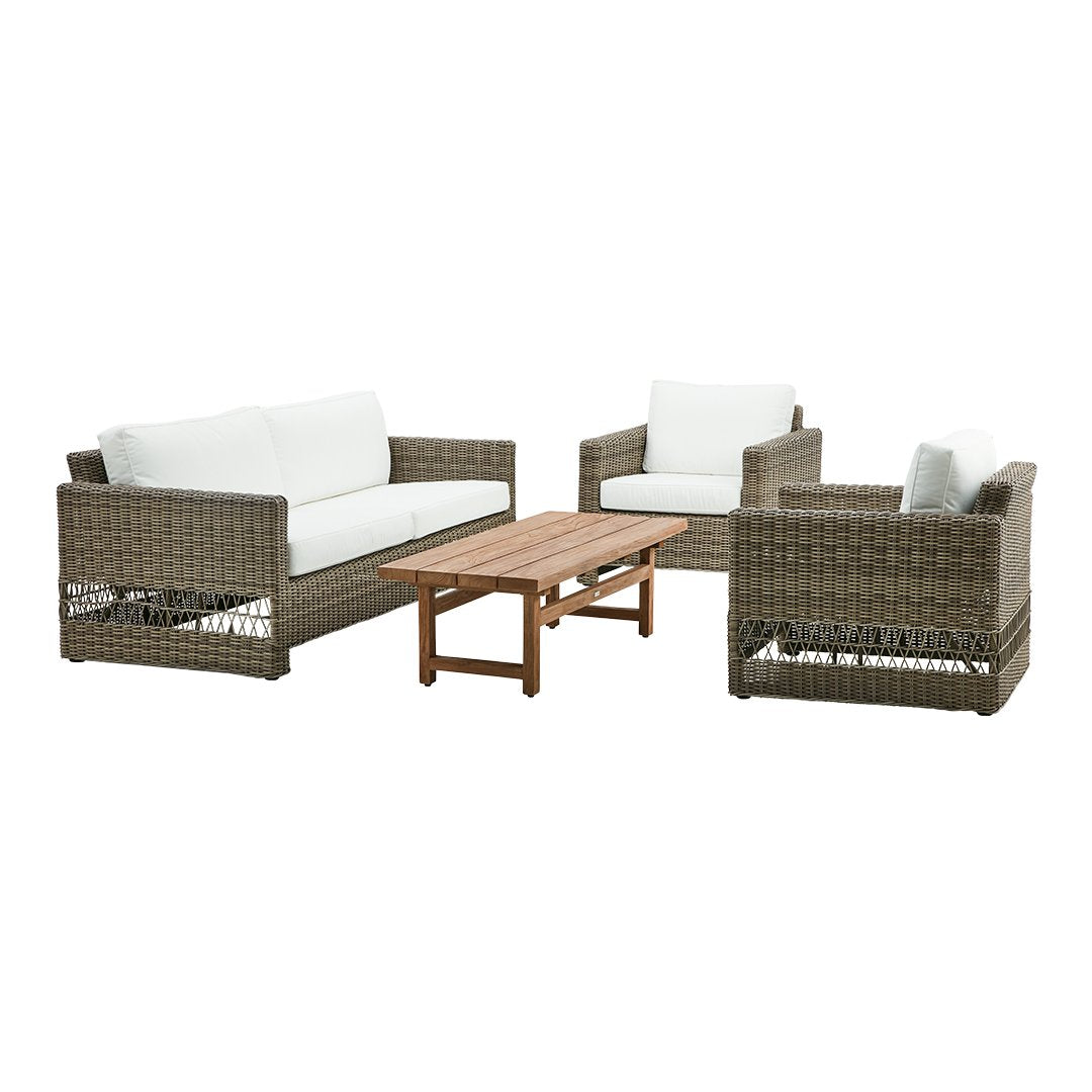 Woven brown rattan patio furniture set with white cushions and a natural wood coffee table. Perfect for outdoor decor.