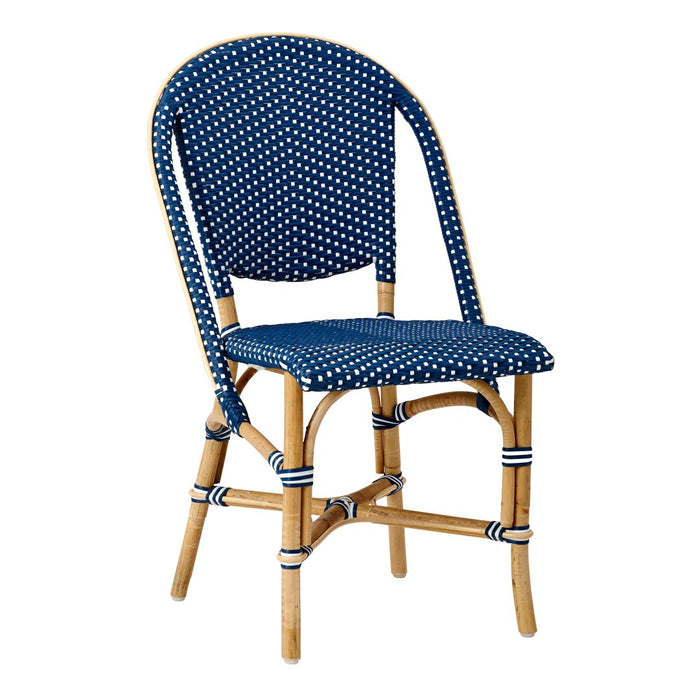 Navy blue chair with white polka dots and classic rattan accents for a stylish and modern look.