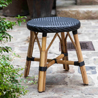 Black woven seat with natural bamboo legs, featuring a sleek and modern design perfect for outdoor use.