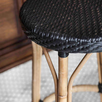 Black woven seat on a natural bamboo bar stool, featuring a modern, textured design against a light backdrop.