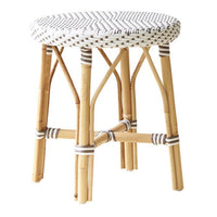 White woven pattern with geometric design on a natural bamboo stool, accented by thin brown stripes.