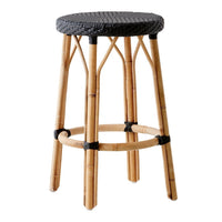 Bamboo bar stool with a woven black seat and natural bamboo legs, showcasing a chic, minimalist design.