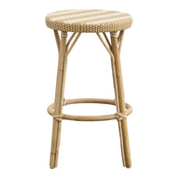 Natural bamboo bar stool with a woven cream and beige striped seat, perfect for coastal decor.