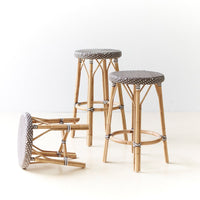 Gray polka-dot upholstered stools with natural bamboo legs, showcasing a stylish mix of textures and patterns.