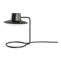 Black lamp with a sleek, minimalistic design featuring a white shade and gold accent. Clean lines and modern style.