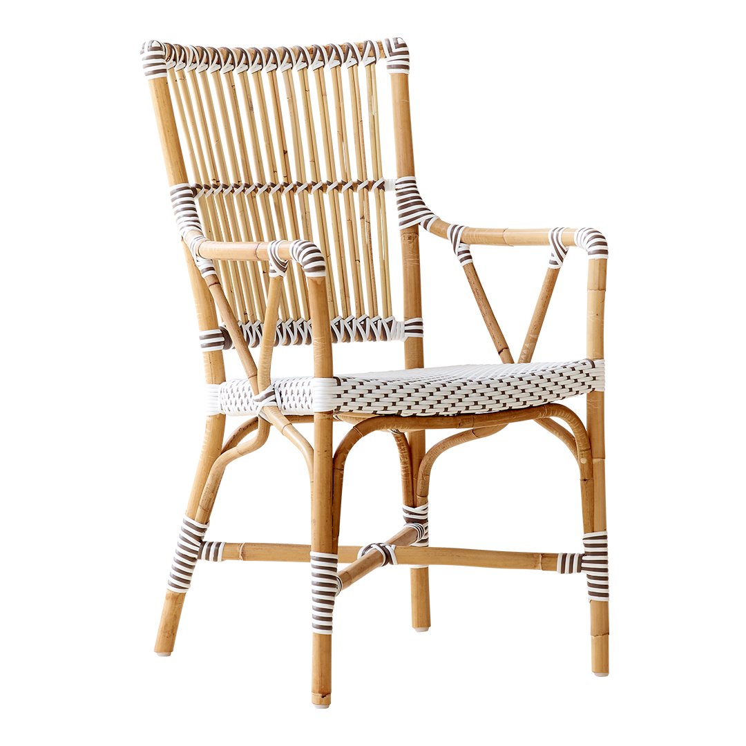"Natural rattan chair with white and black striped accents, featuring a classic woven pattern."