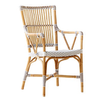 "Natural rattan chair with white and black striped accents, featuring a classic woven pattern."