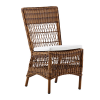 Brown wicker chair with a geometric pattern and white cushion, perfect for outdoor or indoor seating.