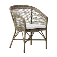 Woven rattan chair in natural tones with a contrasting white cushion for a stylish, modern look.