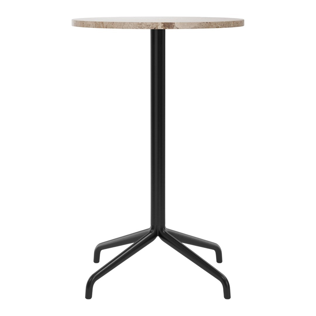Round beige table top with a textured finish, supported by a sleek black metal base. Modern design and neutral colors.