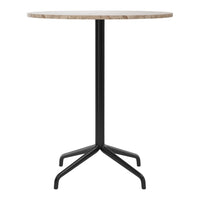 Round, light-colored marble tabletop with a sleek black metal base in a modern design. Ideal for contemporary decor.