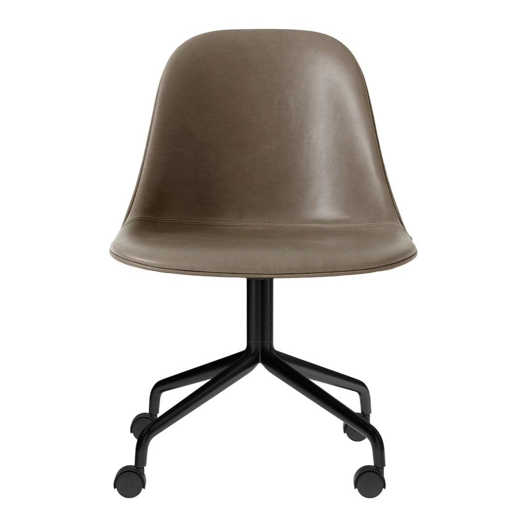 Brown molded chair with a smooth surface and a black, wheeled base. Perfect for modern, minimalist decor.